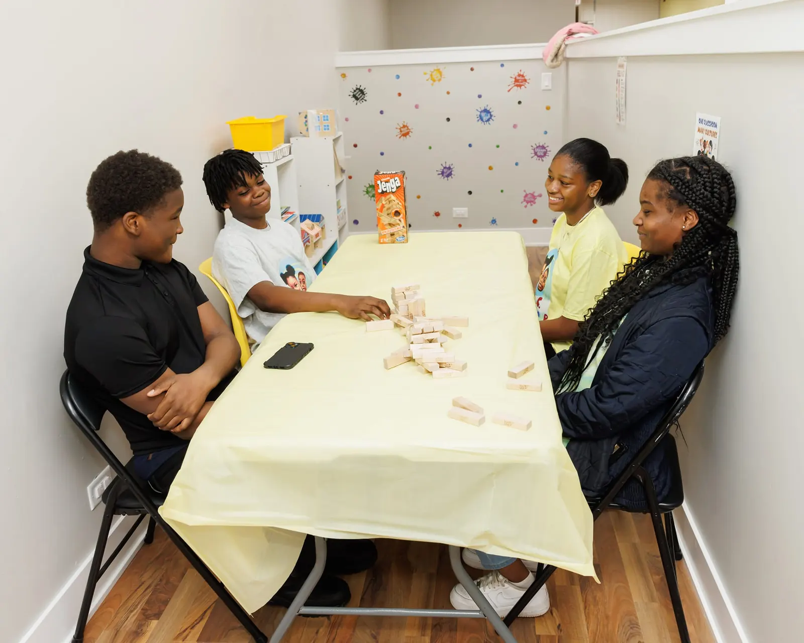 School-age children playing a stacking block game at a table