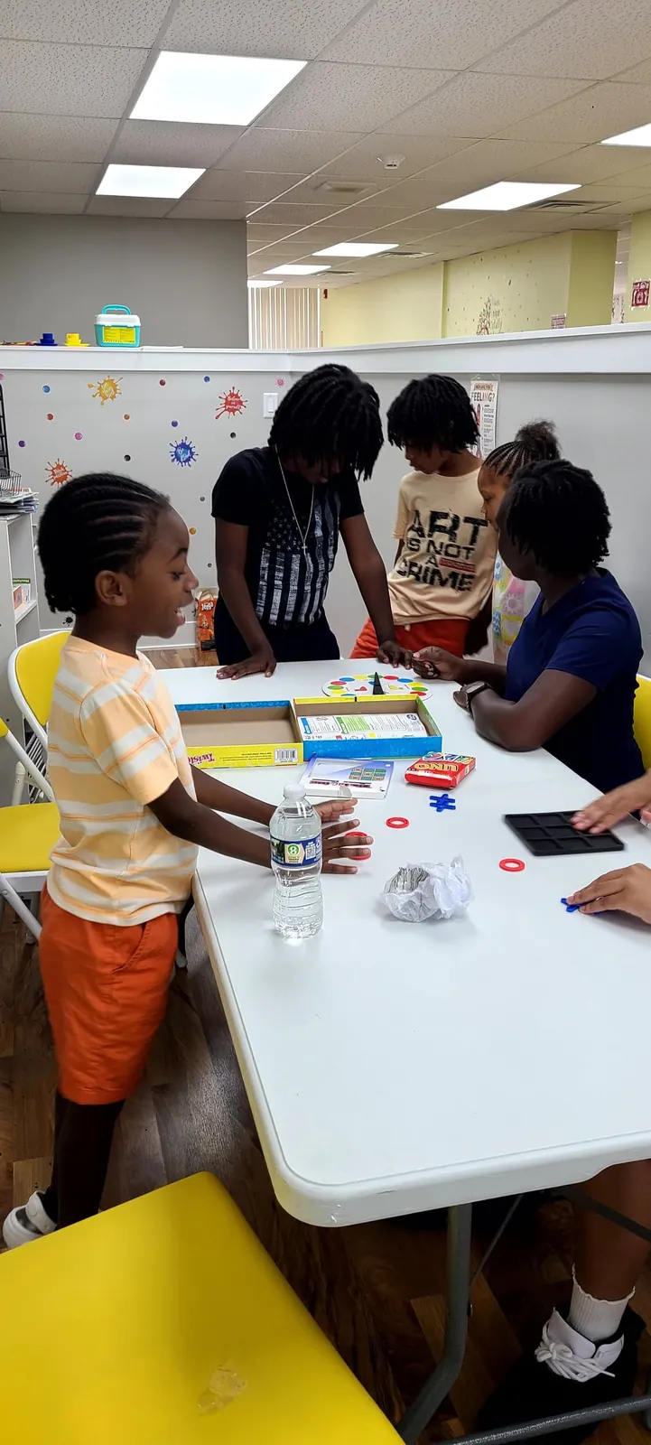 Children playing a game together at a long table