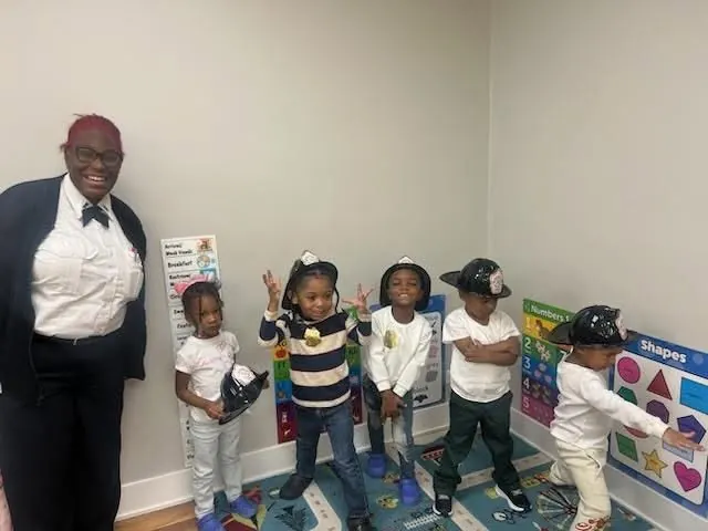 Little ones lined up in caps for a celebration