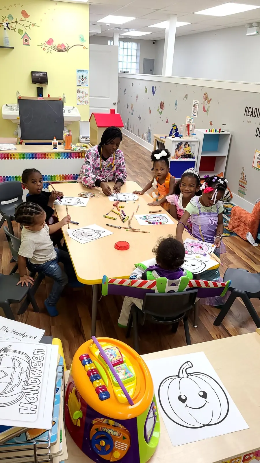 Children gathered around a classroom table for a craft activity